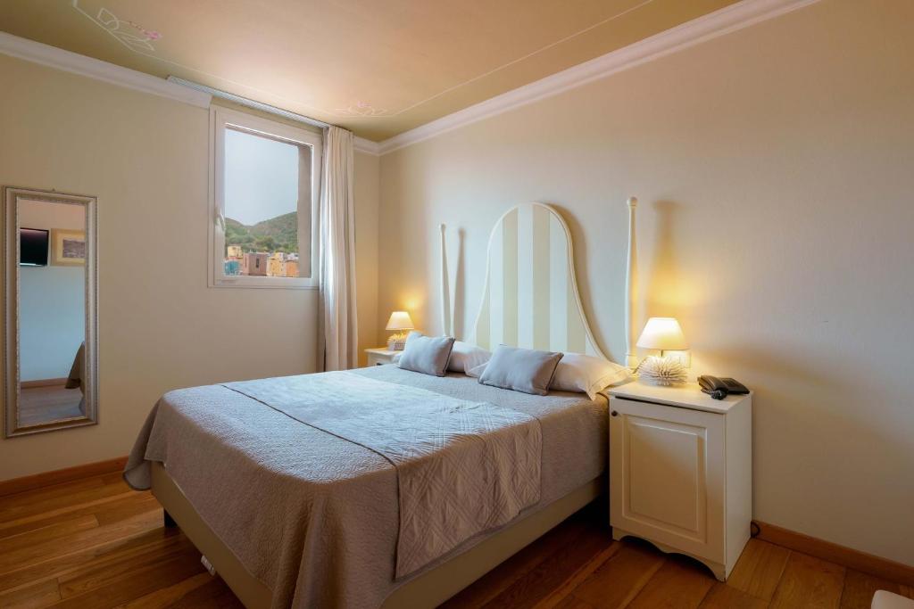 Giường trong phòng chung tại Palazzo Pischedda