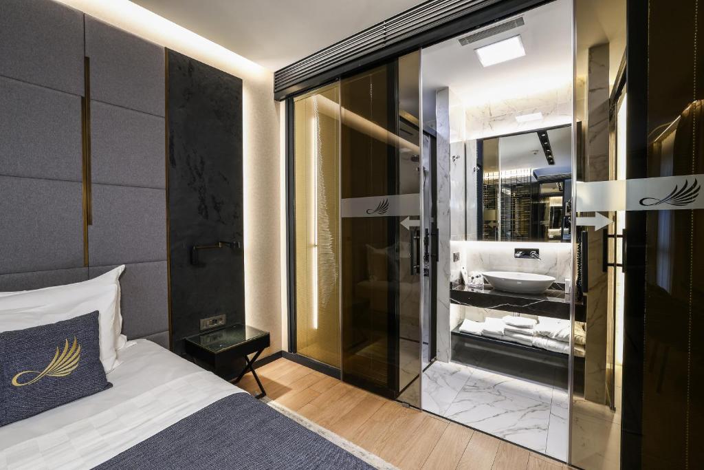 a bedroom with a bathroom with a bed and a sink at Broyt Hotel in Istanbul