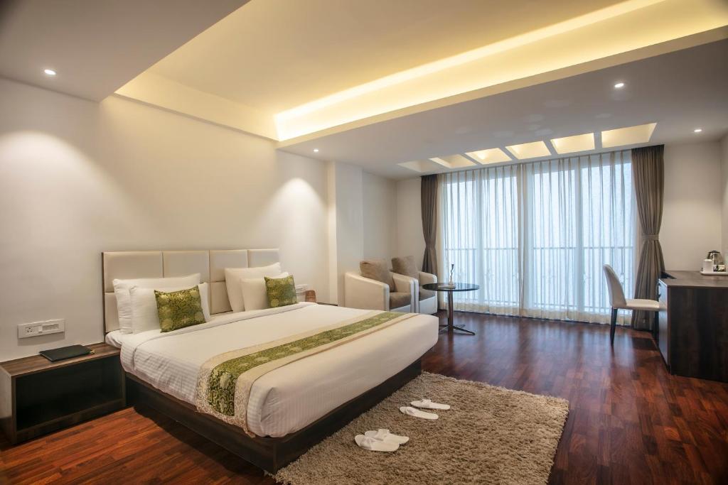 a hotel room with a large bed and a desk at Magpie Libing Grand (MG Marg) in Gangtok