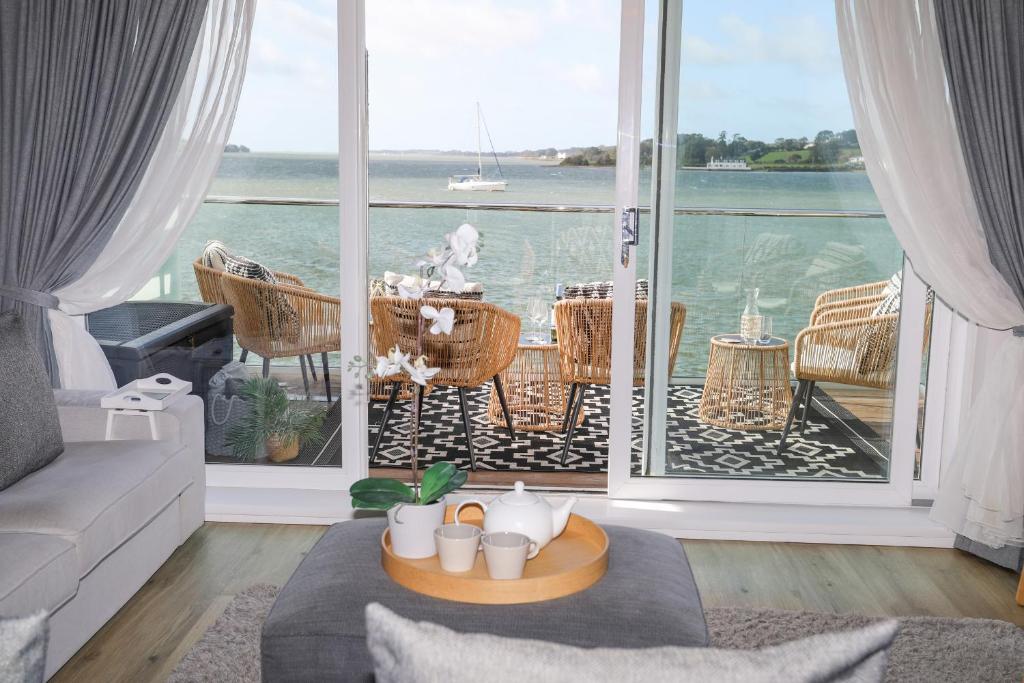a living room with a view of the ocean at Seaclusion in Y Felinheli