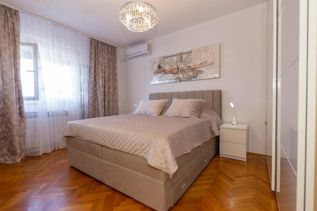Postel nebo postele na pokoji v ubytování Apartman Dragomir