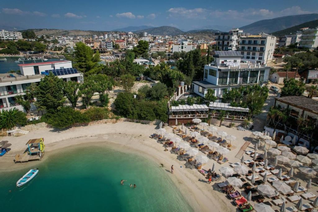 una vista aerea su una spiaggia con ombrelloni e sull'oceano di HOTEL DENOEL a Ksamil