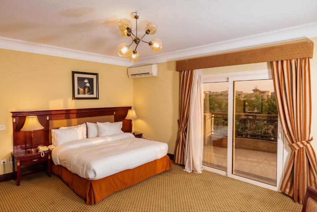 カイロにあるThe Villa 604 Powered by lookのベッドとバルコニー付きのホテルルーム