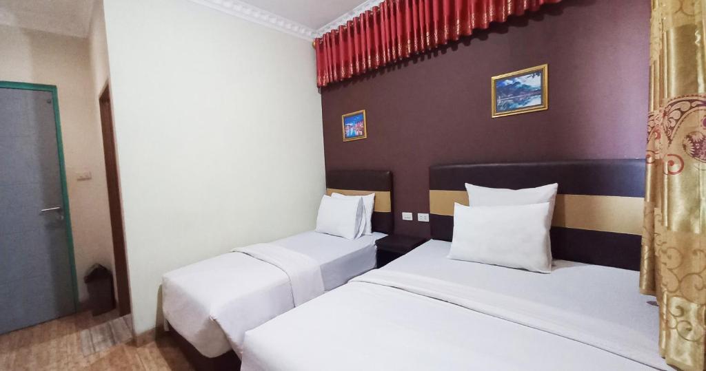 Postel nebo postele na pokoji v ubytování Hotel Syariah GS HERITAGE, Kota Metro