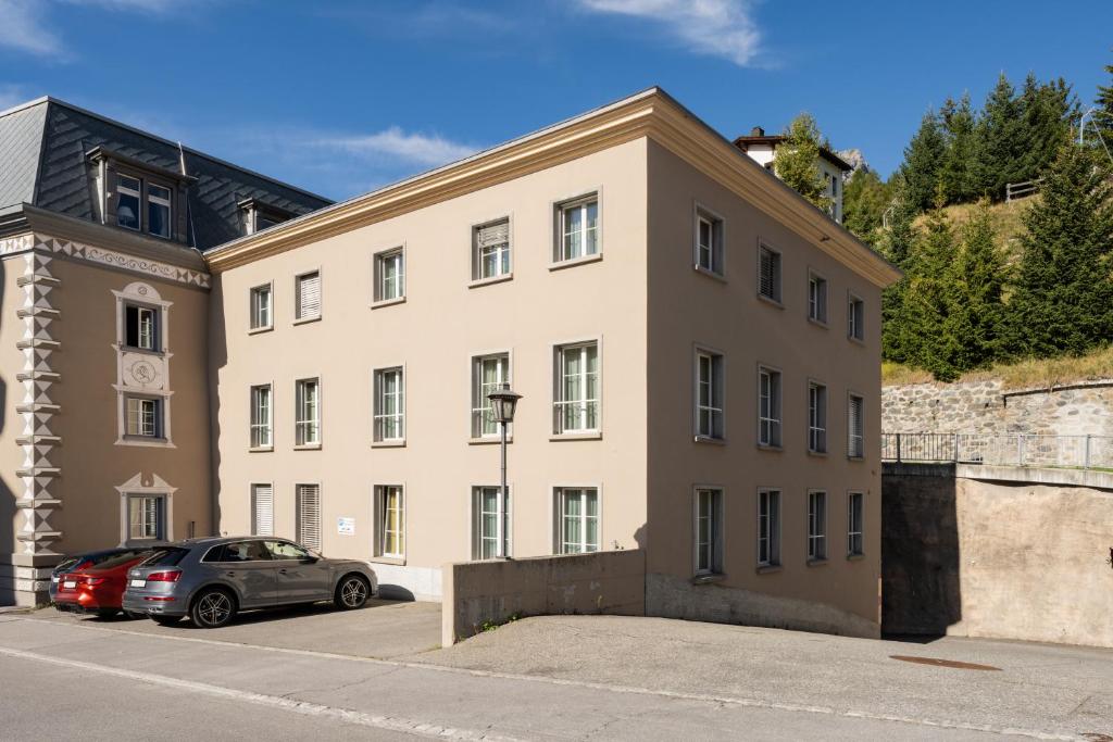 a large building with cars parked in front of it at Seehof Reduit in Davos