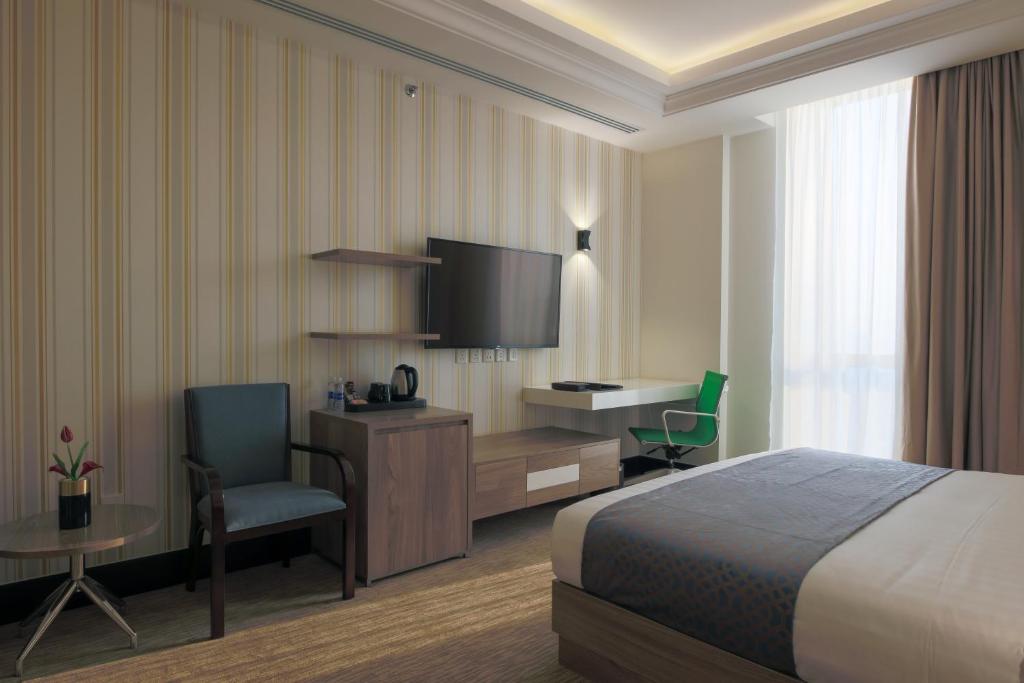 Postel nebo postele na pokoji v ubytování The Proud Hotel Al Khobar