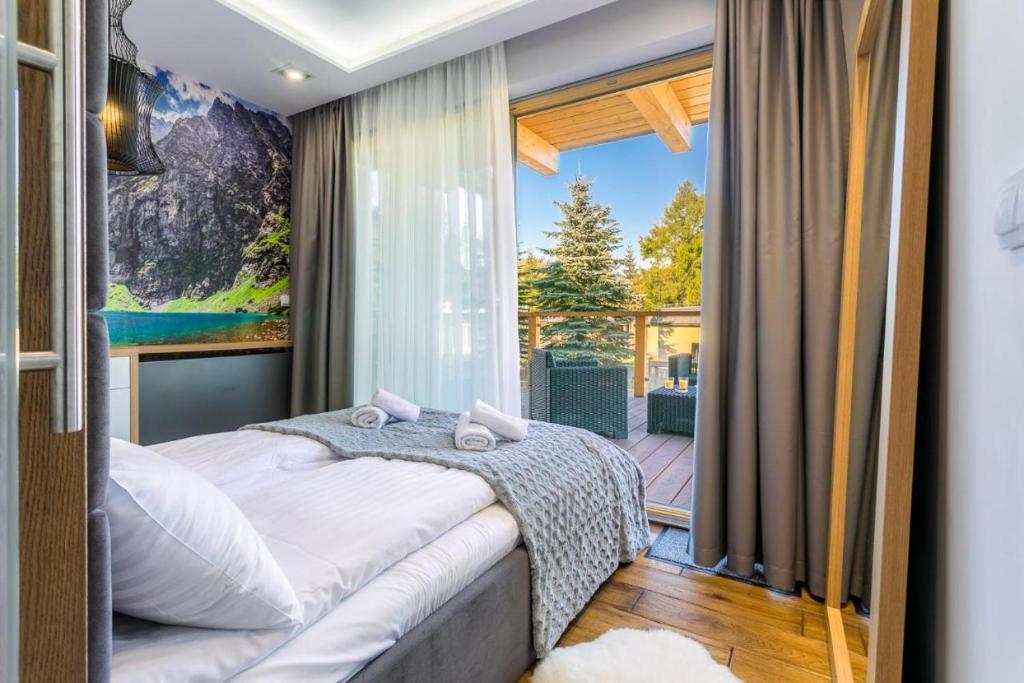 Posteľ alebo postele v izbe v ubytovaní POD SKOCZNIA SPA Zakopane