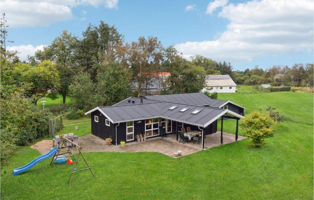 an aerial view of a black house with a playground at Lovely Home In Strandby With Kitchen in Strandby