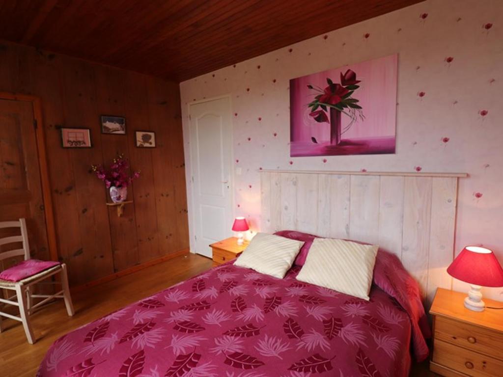 a bedroom with a bed with a purple comforter at Gîte Sansac-Veinazès, 3 pièces, 4 personnes - FR-1-742-114 