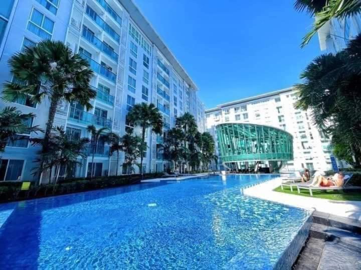 a large swimming pool in front of a building at City Center Residence - Pool view in Pattaya Central
