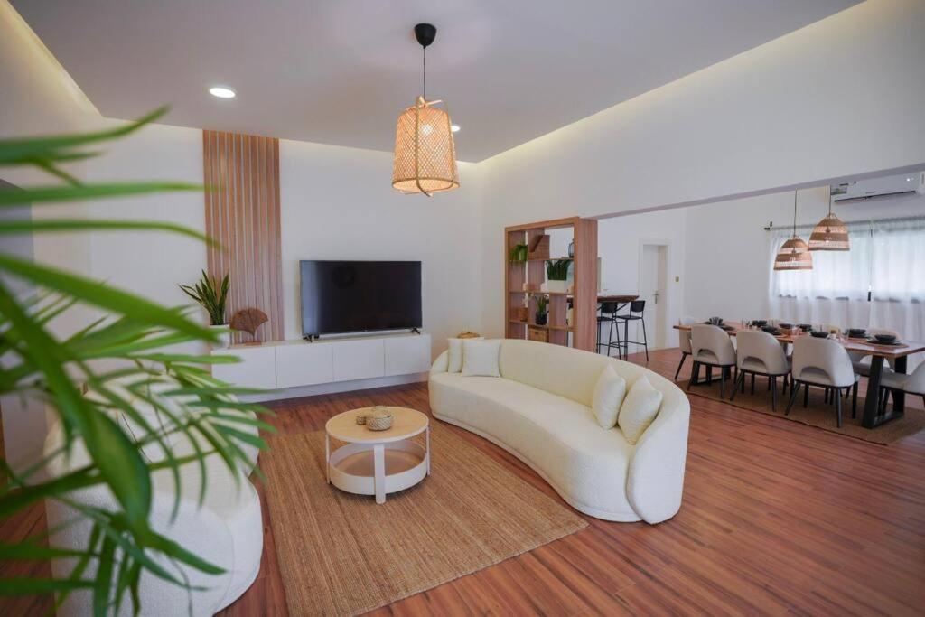 a living room with a white couch and a table at Perfect villa for your vacation in Dubai