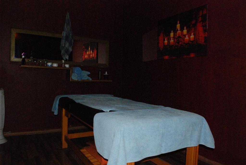 a dark room with a bed with a blanket on it at Maximum hamam Spa in Kusadası