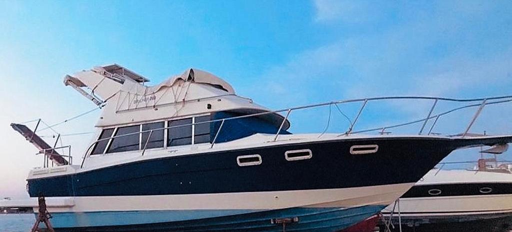 a black and white boat sitting in the water at Thalassa in Katakolo