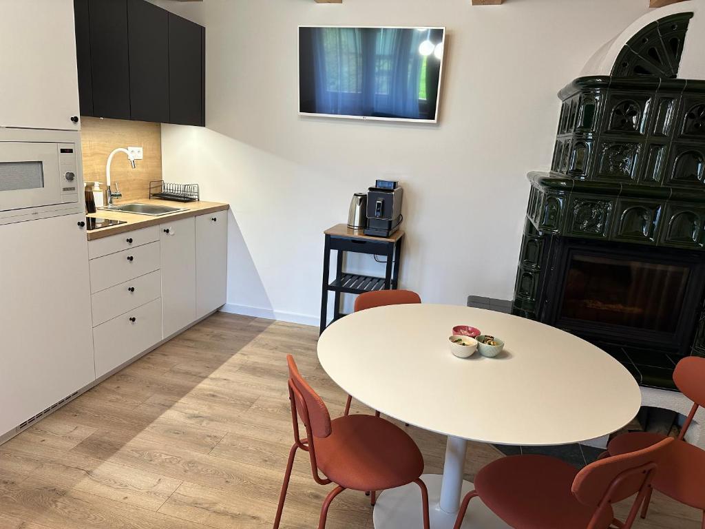 a kitchen with a table and chairs and a sink at Apartmánik pri Zubačke in Tatranska Strba