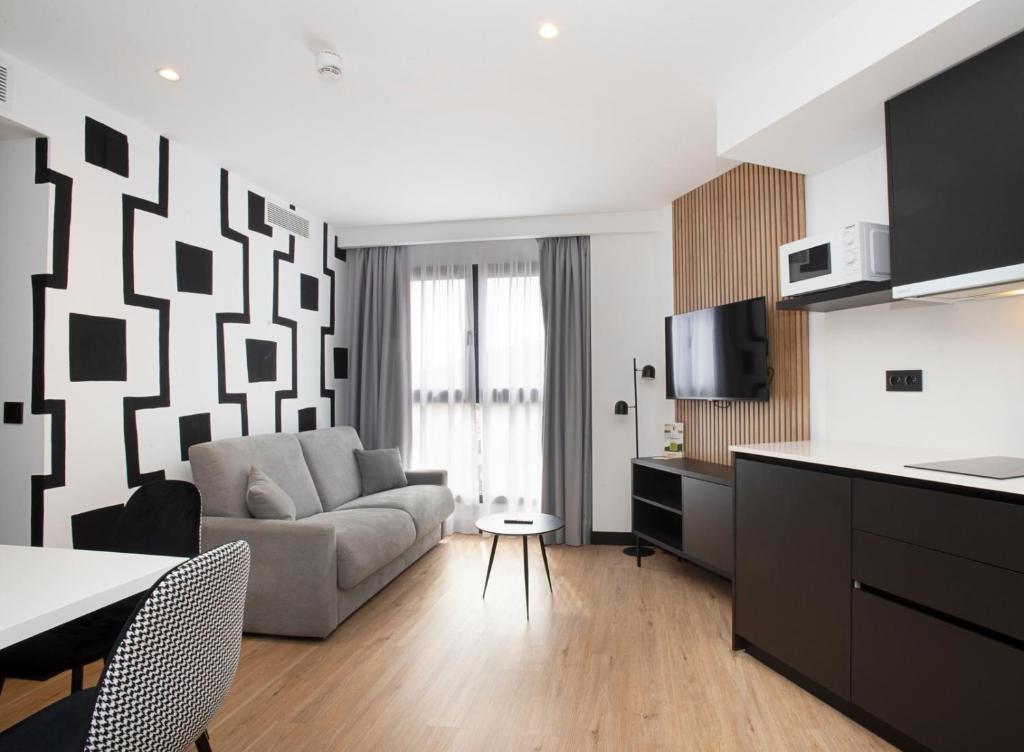 TV a/nebo společenská místnost v ubytování Sercotel Plana Suites