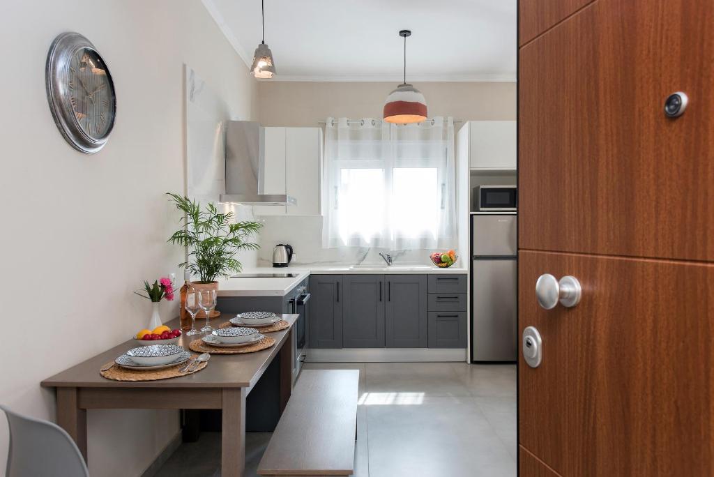 a kitchen with a table with plates of food on it at Aris by Anita Holiday Homes in Ágios Rókkos