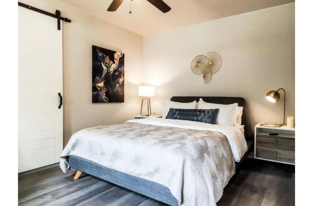 a bedroom with a large bed and a ceiling fan at Charming Studio wDeck Garden in San Antonio