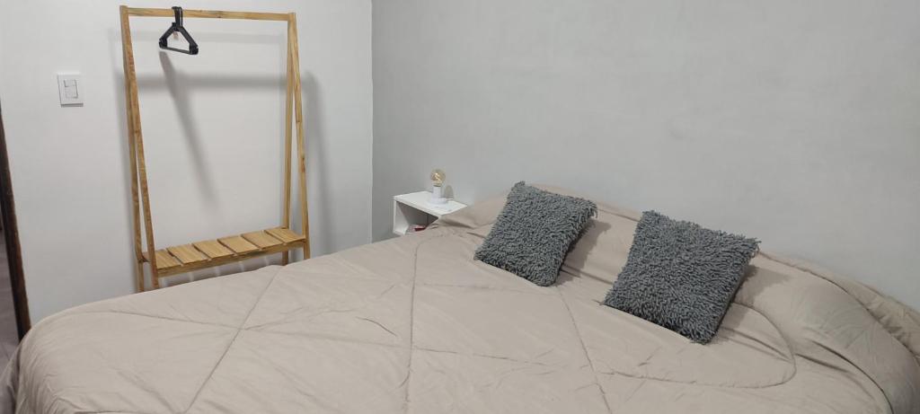 a bedroom with a bed with two pillows on it at Nuestra Casa en Paso in Paso de la Patria