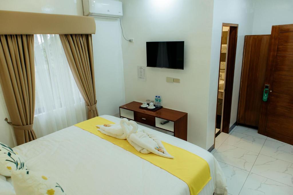 Postel nebo postele na pokoji v ubytování AMYLIE INN