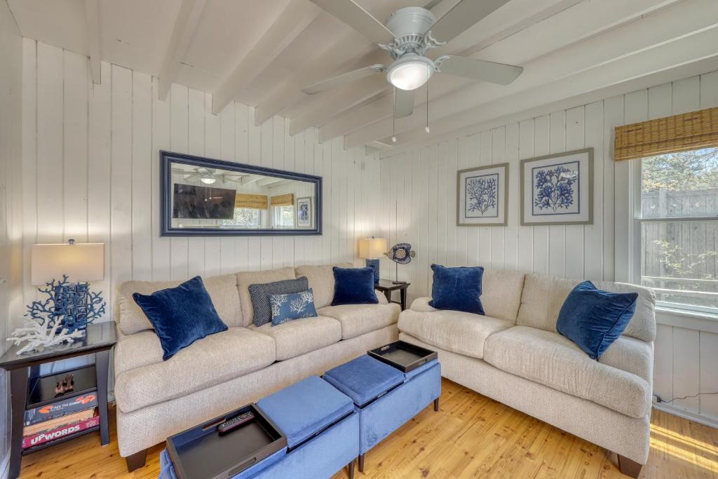 a living room with a couch and blue pillows at The Surfcomber Multi-Residence Home in Ocean Bay Park