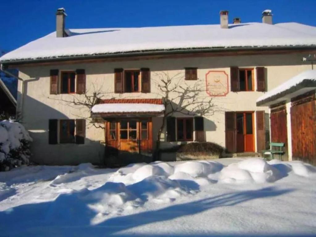 a house with snow on the ground in front of it at La Chaumière in Les Contamines-Montjoie