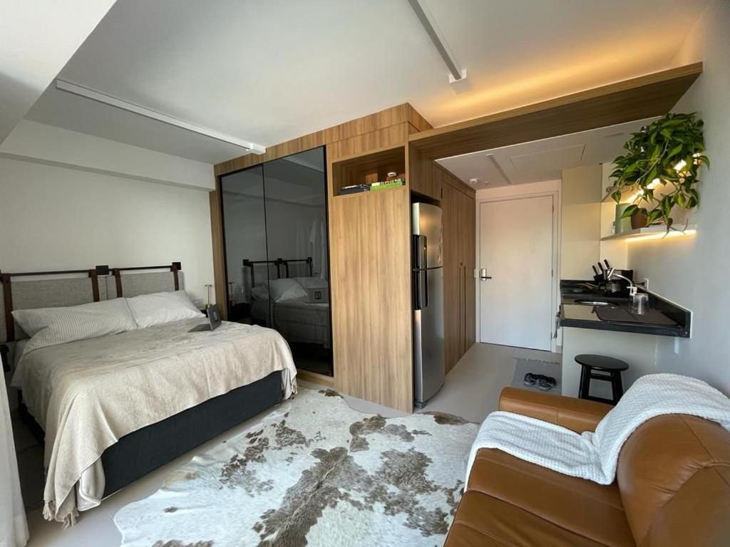 a bedroom with a bed and a sink in it at Vossa bossa Vila Madalena in Sao Paulo