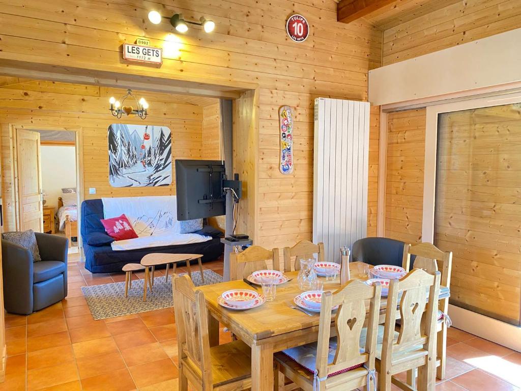 une salle à manger avec une table et des chaises et une télévision dans l'établissement Location aux Gets : Appt 3* pour 6 pers, proche centre et pistes, WiFi, parking, casier à skis - FR-1-623-343, aux Gets