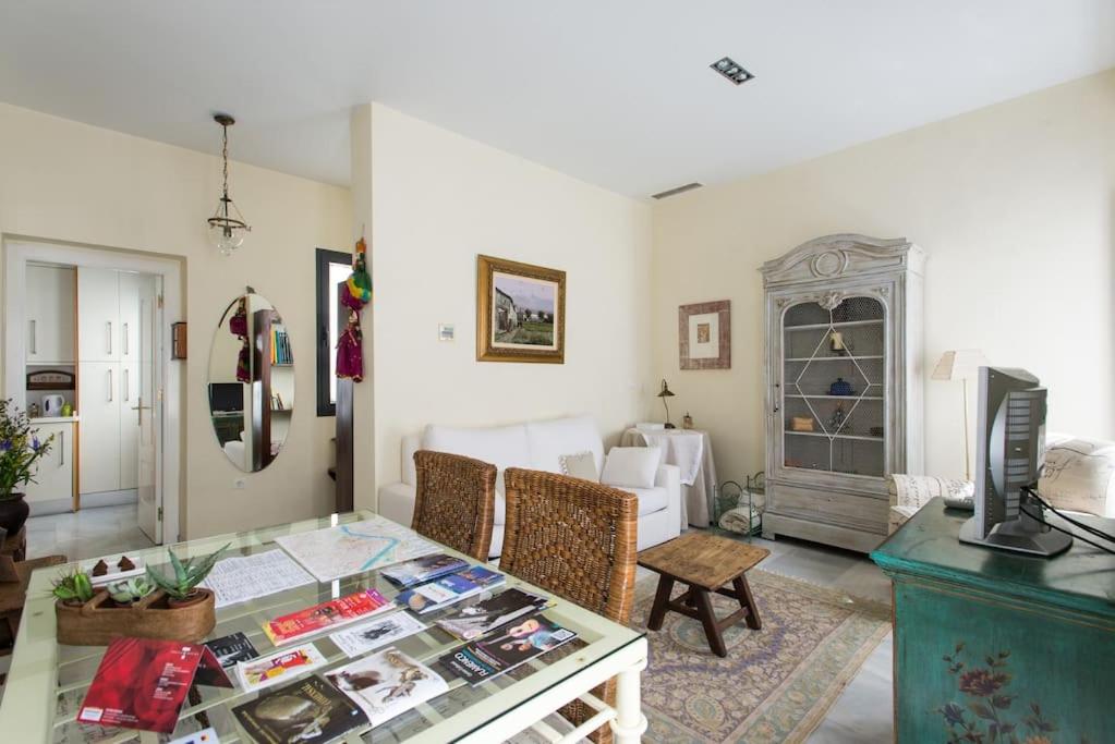 a living room with a glass table and chairs at Apt. Sierpes-Cuna, wifi, HVAC (VFT/SE/00239) in Seville