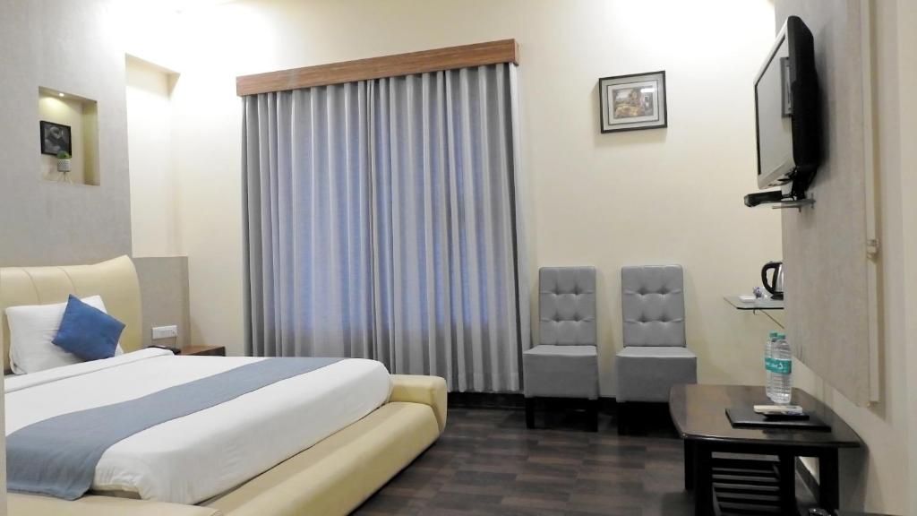 Postel nebo postele na pokoji v ubytování Hotel Sai Miracle
