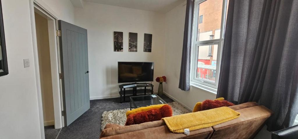 a living room with a couch and a tv at City Blessed Aptm 5 with free parking in South Shields