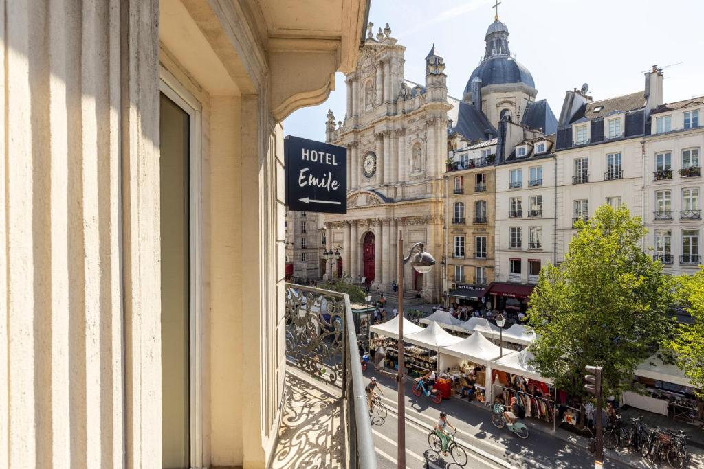 a balcony with a view of a street and buildings at Hôtel Emile Le Marais in Paris