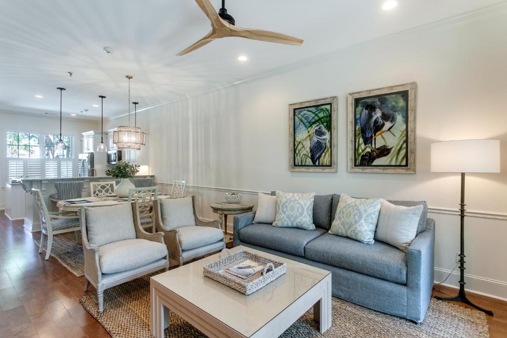 a living room with a couch and a table at Luxe Jekyll Island Home with Beach and Pool Access in Jekyll Island