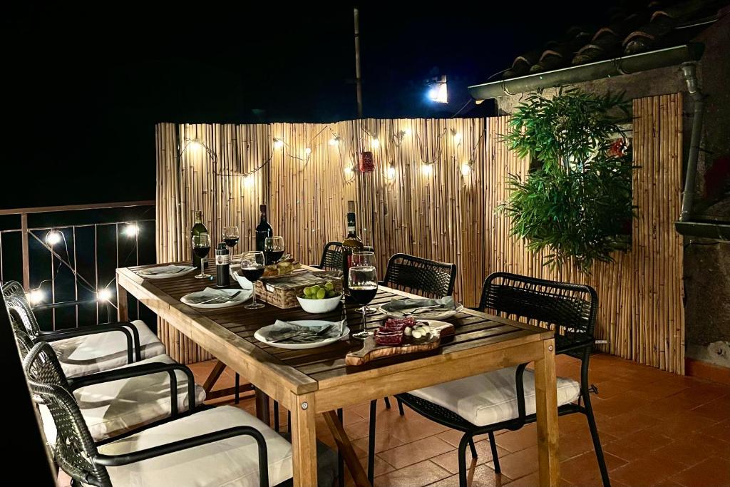 a wooden table with chairs and a tableasteryasteryasteryasteryasteryasteryasteryastery at Central, Stylish with Terrace 6 Pax in Volterra
