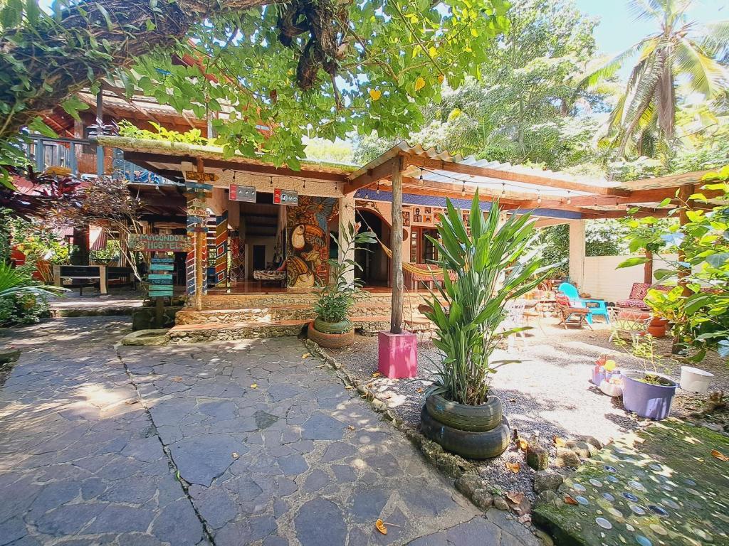 a house with a porch and a patio at Macondo Hostel in Isla Grande
