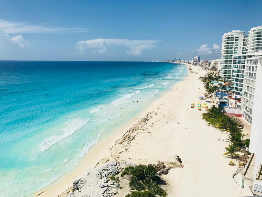 an aerial view of the beach in front of condos at 2 Story Oceanfront Penthouses on Cancun Beach! in Cancún