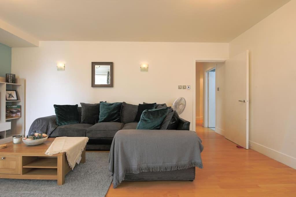 a living room with a couch and a table at 2 bed spacious apartment in Cardiff CC in Cardiff