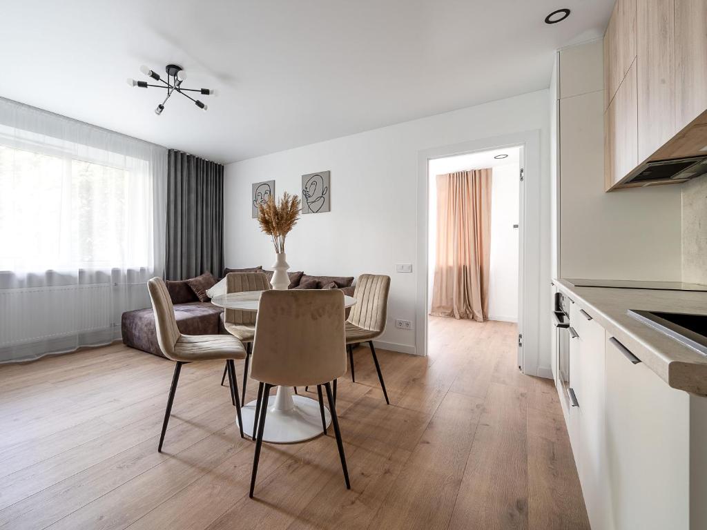 a kitchen and living room with a table and chairs at Modern 2 bedroom Vytenio apartment in city centre I Self check-in in Vilnius