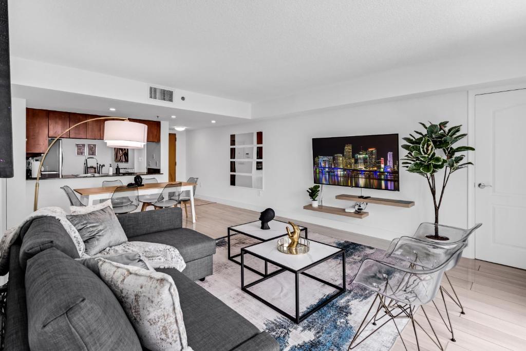a living room with a couch and a table at LUX 2B/2B Brickell - Free Parking in Miami