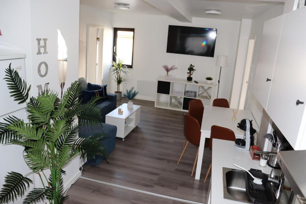 a living room with a kitchen and a dining room at Sandnes Central Suite in Sandnes