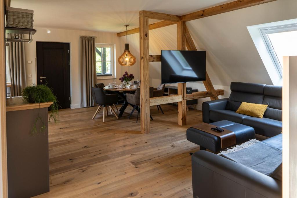 a living room with a couch and a dining room at Spreewald Chalet Wohnung in Kolonie