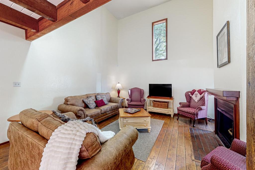 a living room with two couches and a tv at Traditions in College Station