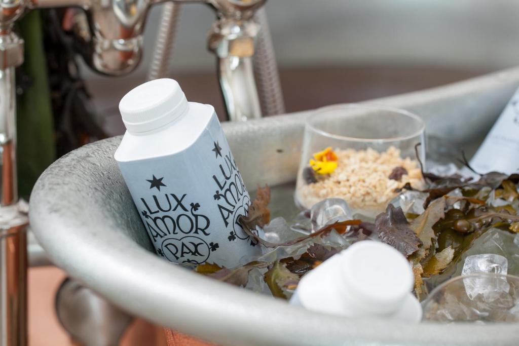 a sink with a bottle of water and food in it at Portmarnock Resort & Jameson Golf Links in Portmarnock