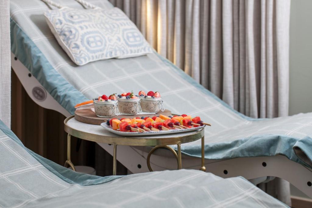 a tray of strawberries on a table on a hospital bed at Portmarnock Resort & Jameson Golf Links in Portmarnock