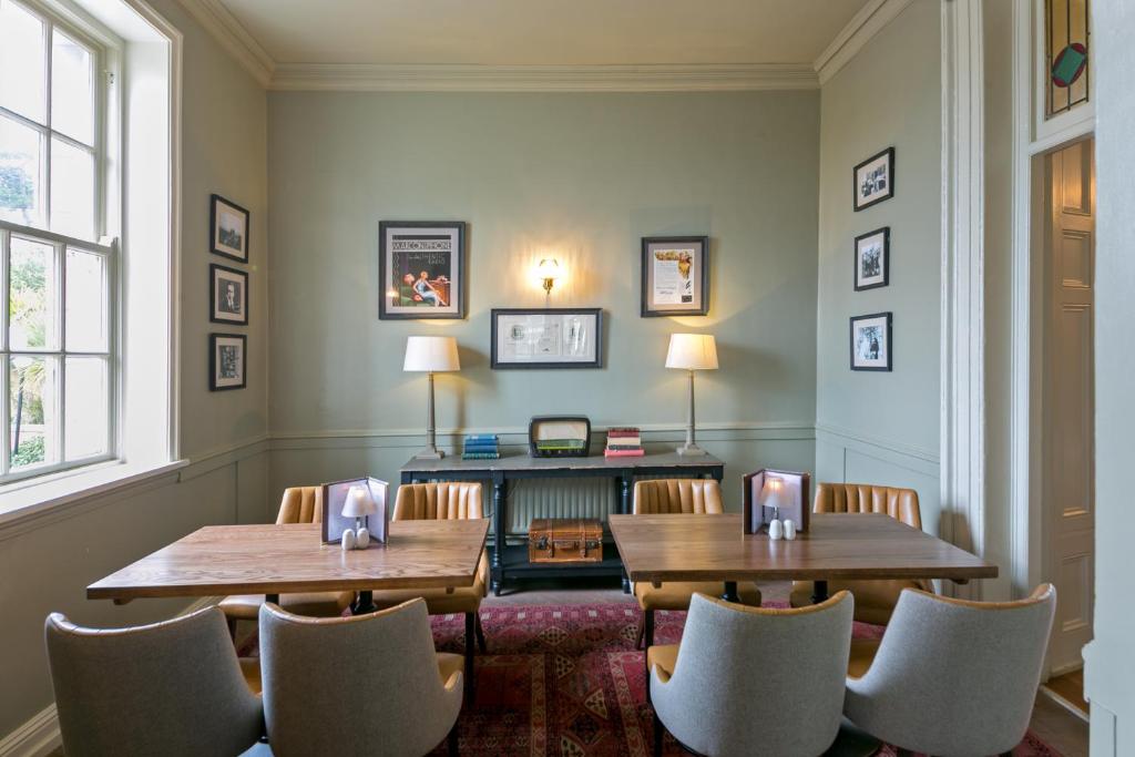a room with two tables and chairs and a desk at Portmarnock Resort & Jameson Golf Links in Portmarnock
