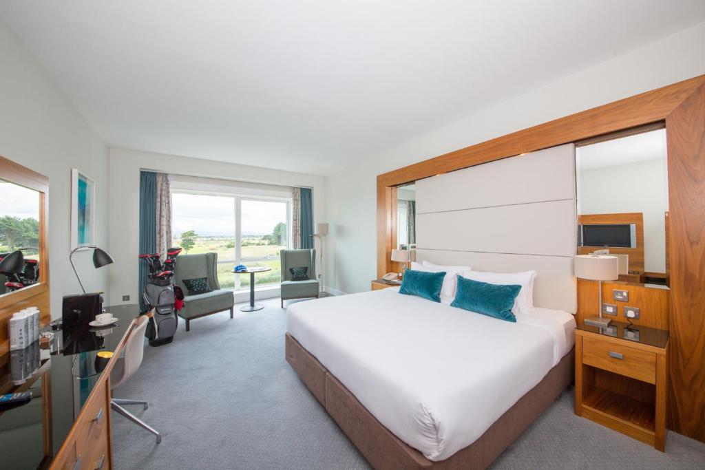 a hotel room with a large bed and a television at Portmarnock Resort & Jameson Golf Links in Portmarnock