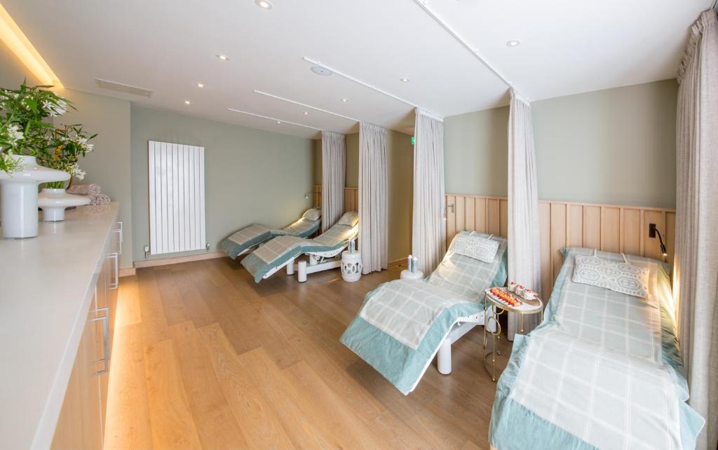 a room with two beds and chairs in it at Portmarnock Resort & Jameson Golf Links in Portmarnock