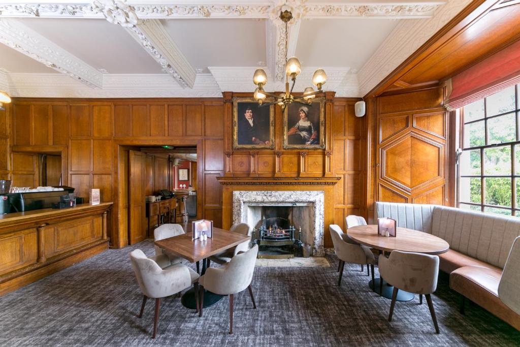 a living room with wood paneling and a fireplace at Portmarnock Resort & Jameson Golf Links in Portmarnock