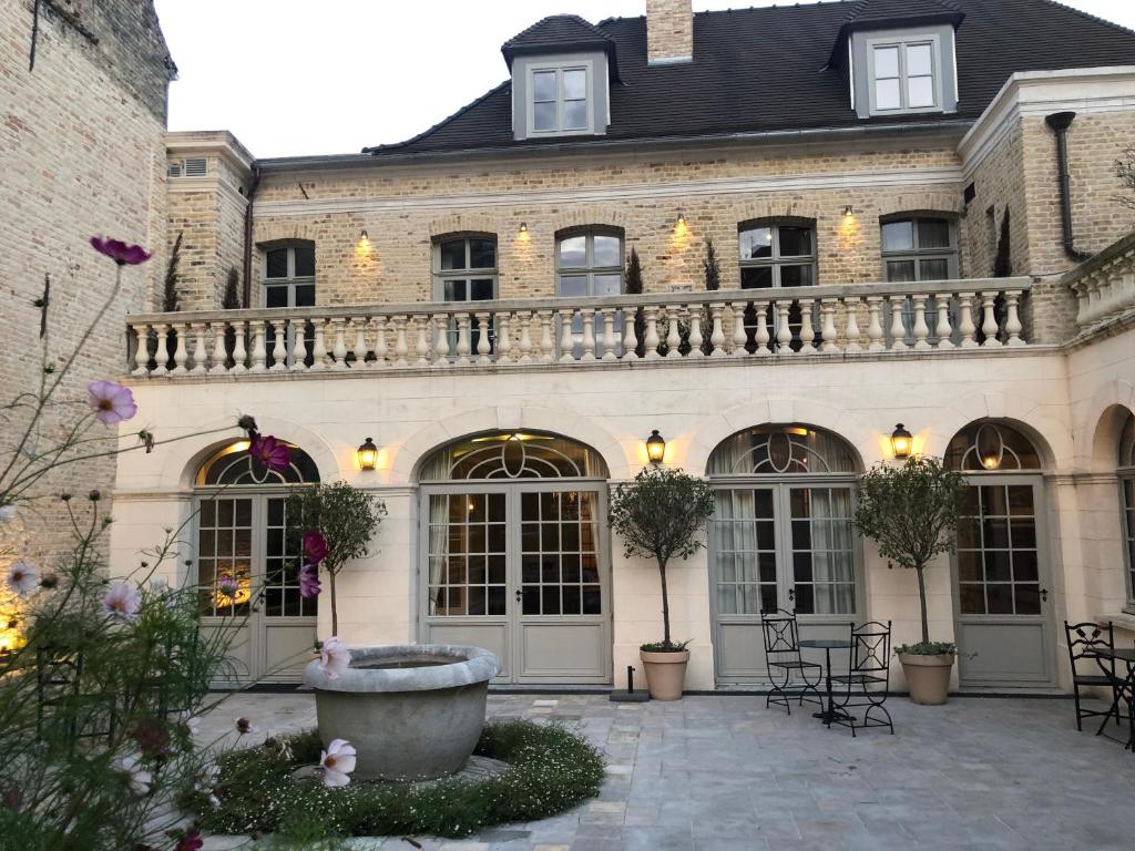 a large building with a balcony and a courtyard at CLOS DU BAILLI in Saint-Omer