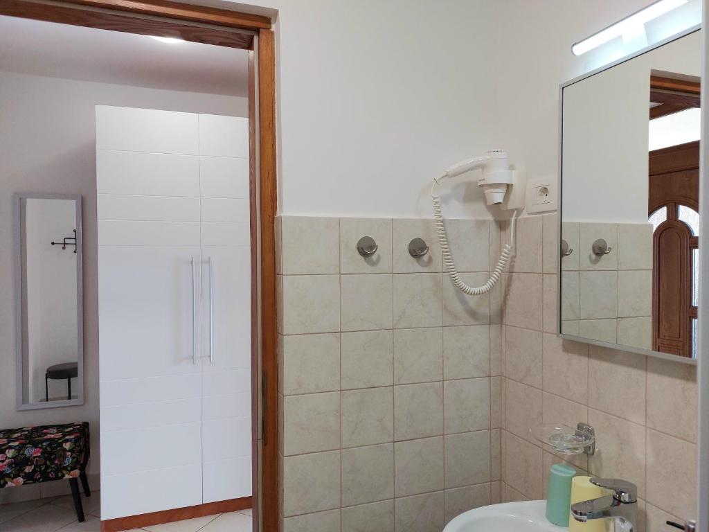 a bathroom with a shower and a sink at Casa Panorama Studio in Rabac