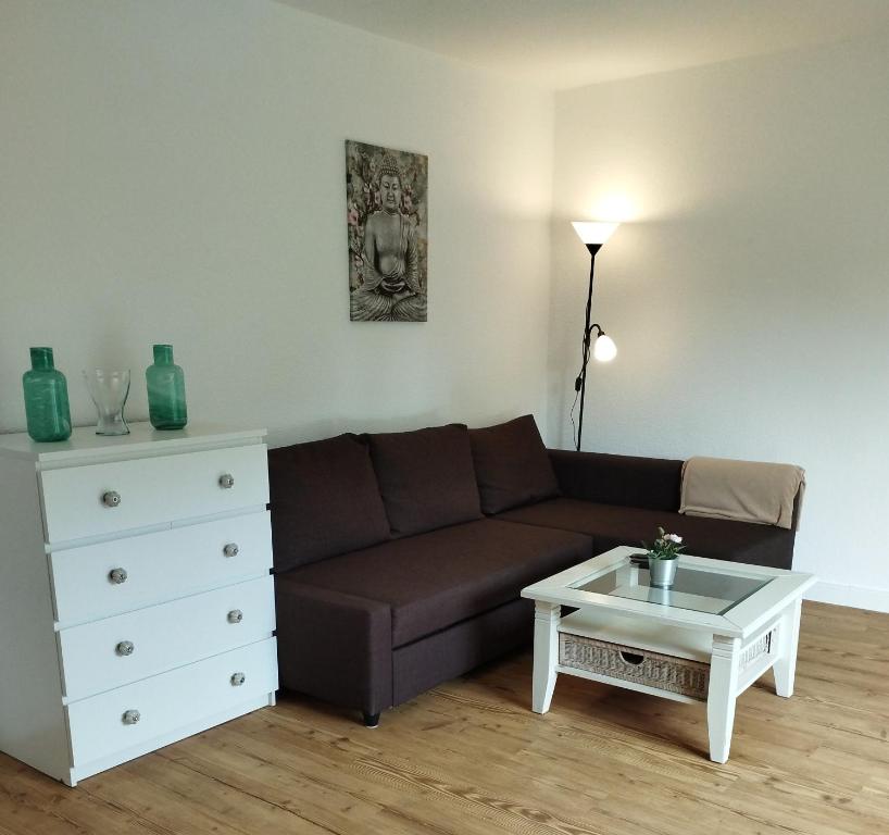 a living room with a couch and a coffee table at Apartment Wittorf in Neumünster